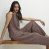 Beige plisserade byxor med vida ben