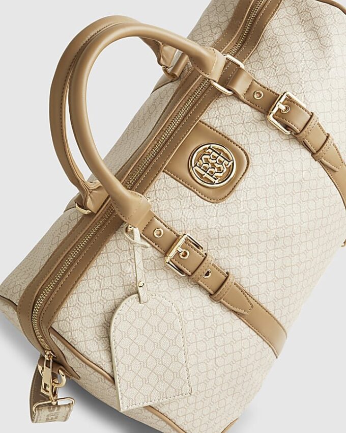 Beige väska med spänne och monogram