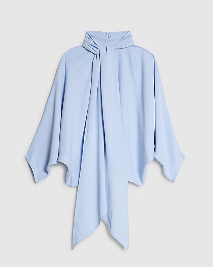 Blå blus med fladdermusärmar och rosett