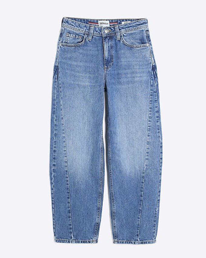 Blå jeans med sömmar och barellben