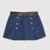 Blå miniskort i denim och plisserat konstläder Blå miniskort i denim och plisserat konstläder