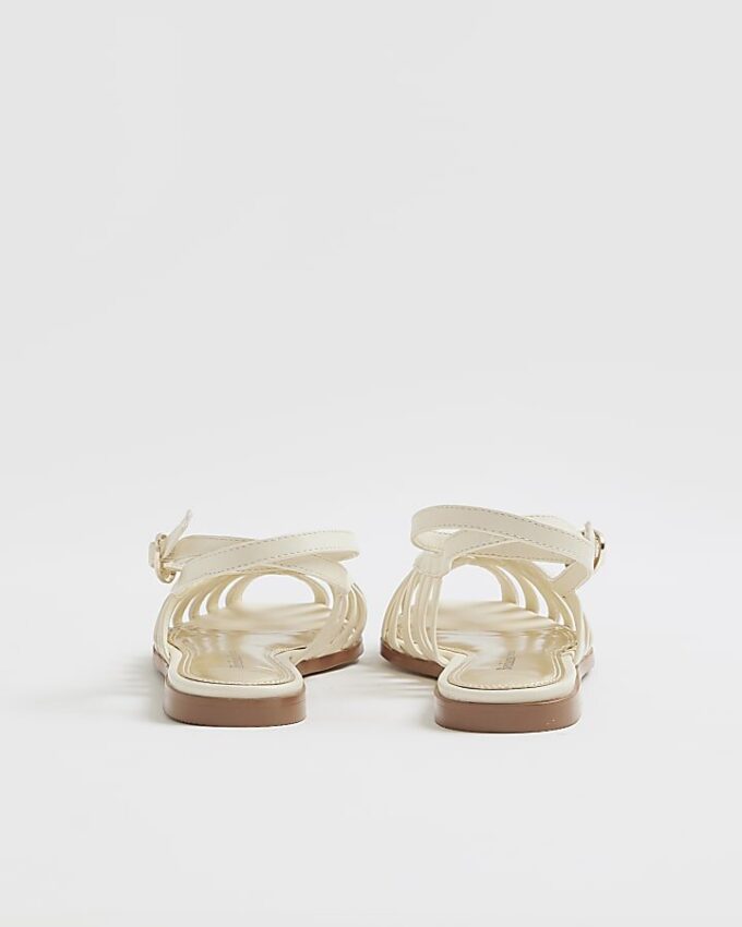 Creamfärgade sandaler i konstläder med burdesign