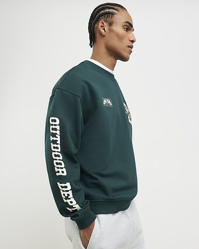 Grön oversized-tröja med alpinbadge