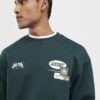 Grön oversized-tröja med alpinbadge