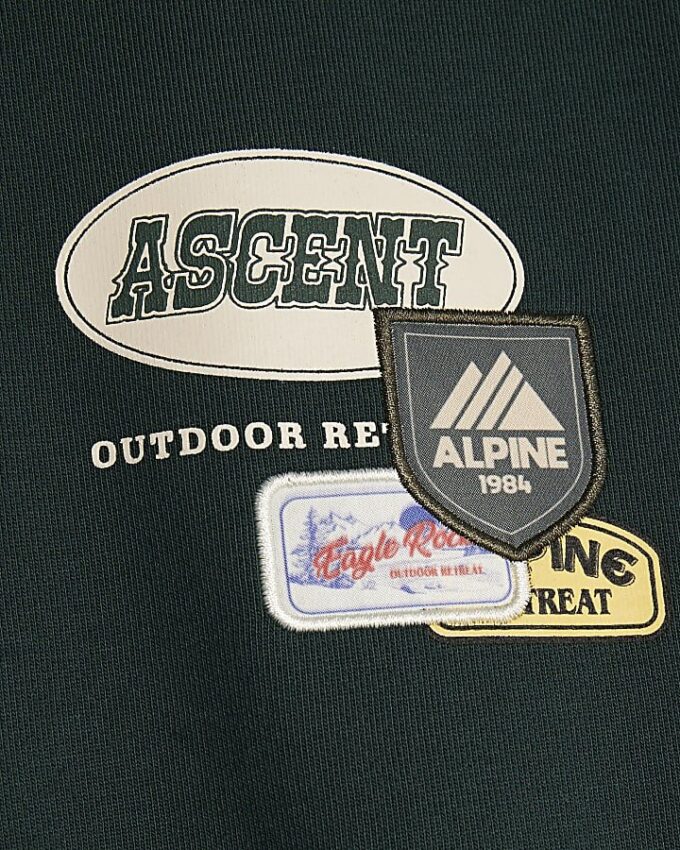 Grön oversized-tröja med alpinbadge