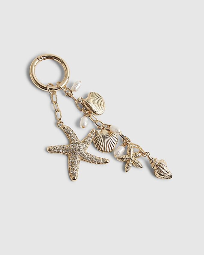 Guldfärgad sjöstjärna som bag charm