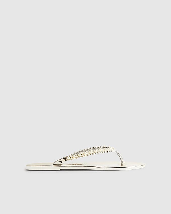 Guldfärgade flip-flops med pärldetaljer