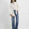 Krämfärgad blus i organza med prickar