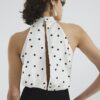 Krämfärgad jumpsuit med halterneck och prickar