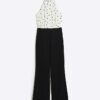 Krämfärgad jumpsuit med halterneck och prickar