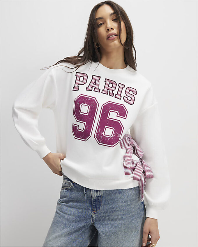 Krämfärgad långärmad tröja med rosett i Paris-stil
