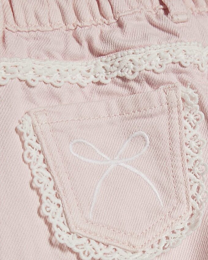 Mini Girls rosa jeans med breda ben och spetsrosett