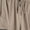 Mini pojkbyxor i beige med dragkedja
