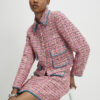 Rosa boucléjacka med whipstitch-sömmar
