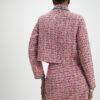 Rosa boucléjacka med whipstitch-sömmar