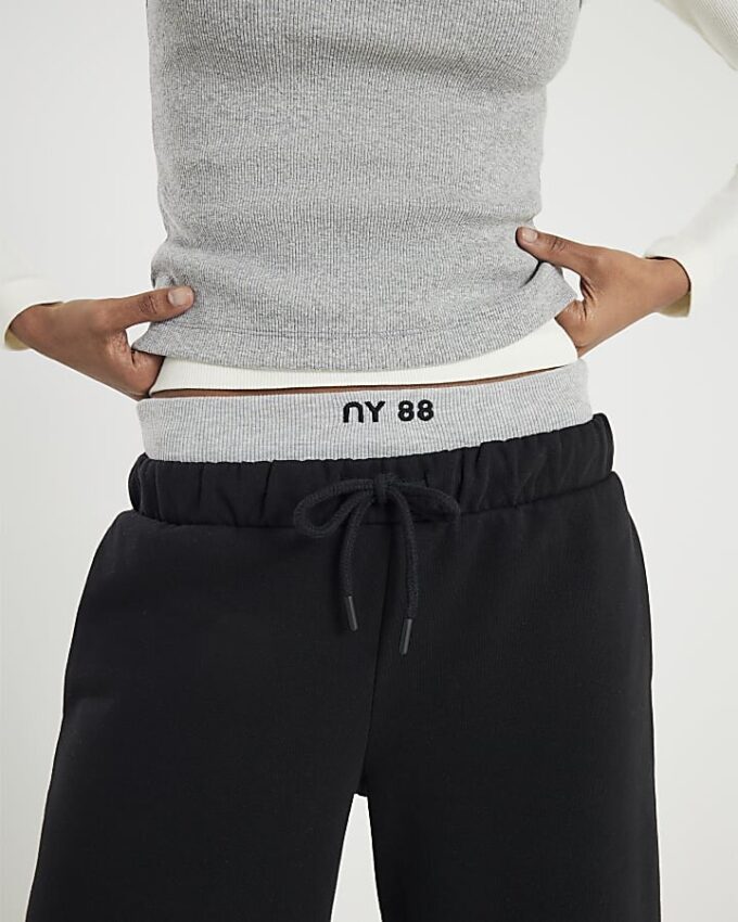 Svart 2-i-1 joggingbyxa med vida ben