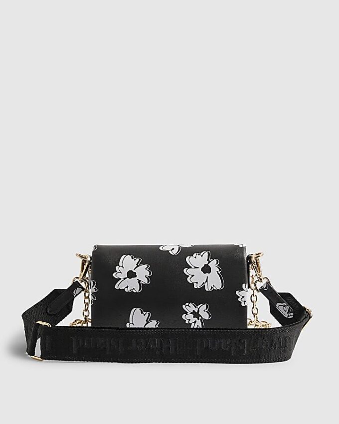 Svart crossbody-väska med daisy-tryck