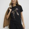 Svart kortärmad T-shirt med metallisk rosett
