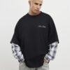 Svart oversized-passad T-shirt med lager på lager-mönster Svart oversized-passad T-shirt med lager på lager-mönster