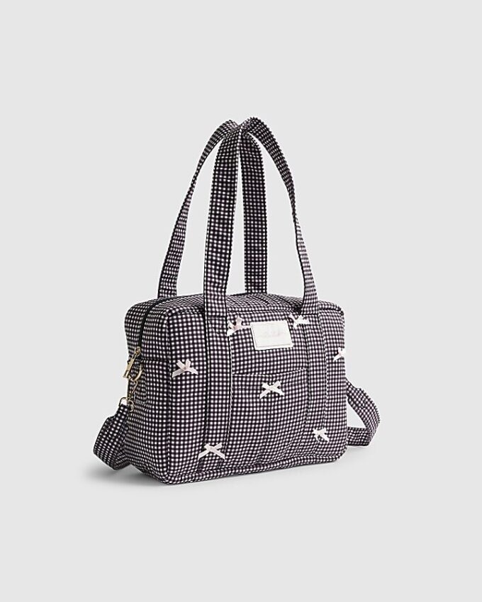 Svart resväska med gingham-mönster och rosett