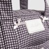 Svart resväska med gingham-mönster och rosett