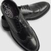Svarta läderbrogues