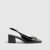 Svarta loafers med spänne och slingback-klack
