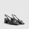 Svarta loafers med spänne och slingback-klack